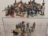 many figurines in a display case on a table