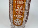 a glass vase with a floral design on it
