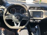 dashboard view of a car with a steering wheel and dashboard controls