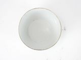 a white bowl on a white table with a white background