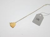 a close up of a gold heart necklace with a price tag