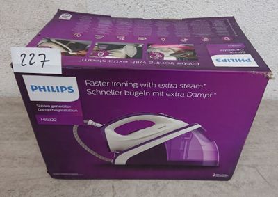 La boîte d'un fer à repasser à vapeur Philips est ouverte par terre.