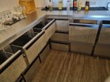 a stainless steel kitchen with a sink and a dishwasher