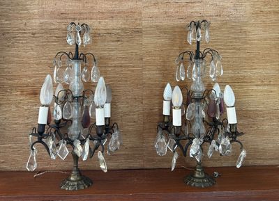 two lamps that are sitting on a wooden shelf