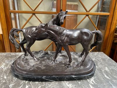 une statue représentant deux chevaux debout sur une table