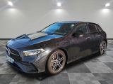 the mercedes cla is parked on a checkered floor in a garage