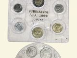 the coins are in a clear plastic bag and are on a white surface