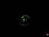 an image of a green glass ball in the dark