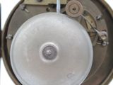 a close up of a clock with a pendulum on it