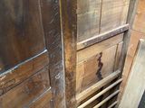 a wooden door that is open in the corner of a room