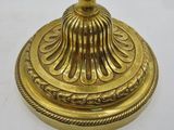 an image of a gold candle holder on a white surface