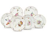 six plates with floral designs on them on a white surface