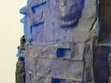 a sculpture of a face on top of a rock