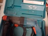 a blue box with a drill and a cord in it