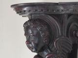 a close up of a wooden shelf with a statue on it
