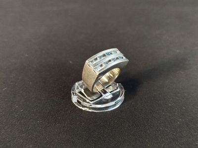 a close up of a ring on a table with a black background