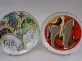 two plates with a painting of a man and a woman on them