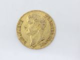 a close up of a gold coin on a white surface