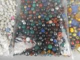many different colored beads in a bag on the table