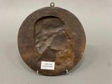 a metal plate with a picture of a woman on it