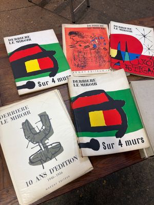 Plusieurs livres sont posés sur une table devant une chaise.