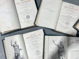 several old books sitting on top of a table next to each other