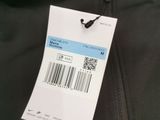 the jacket is black and has a white tag on it