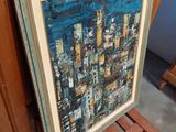 painting of a cityscape in a frame sitting on a wooden chair