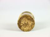 a close up of a gold colored metal object on a white surface