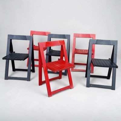 several chairs are arranged in a row on a white surface