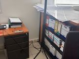 a desk with a chair and a computer on it