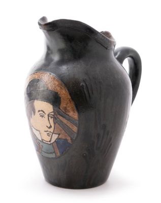 a black vase with a picture of a man on it
