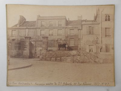 an old photo of a building with a horse in front of it
