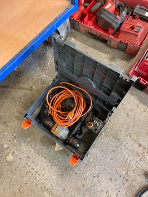 a tool box with a corded cord in it on the floor