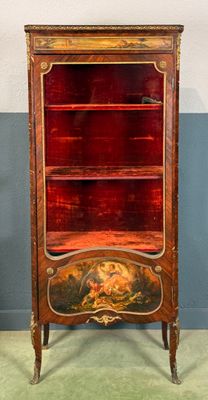 an old wooden cabinet with a red glass door and gold trimming