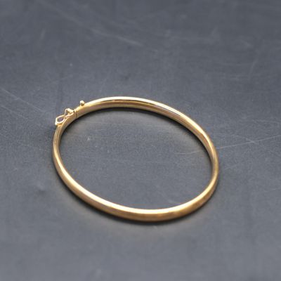 a close up of a gold ring on a black surface