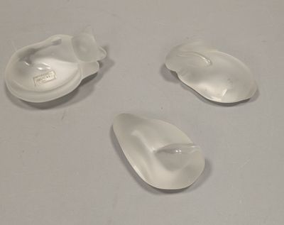 three plastic spoons sitting on a table with a white surface