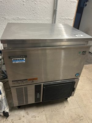 an image of a stainless steel freezer sitting on top of a tiled floor