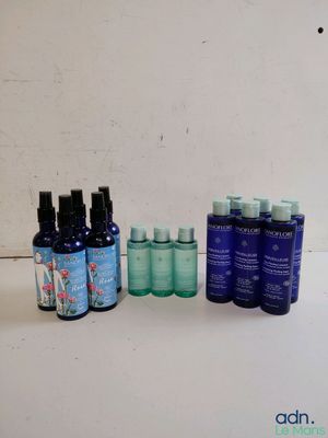 some bottles of different types of skin care are lined up on a table