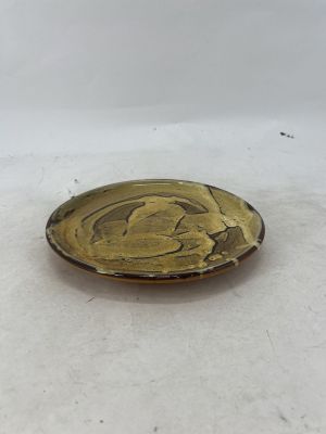 a close up of a small glass object on a white surface