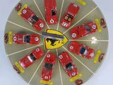 a picture of a clock with a lot of toy cars on it