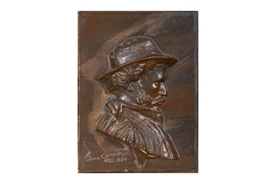une plaque en bronze représentant un homme portant un chapeau et une barbe