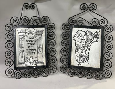 two framed pictures of a dog and a cat hanging on a wall