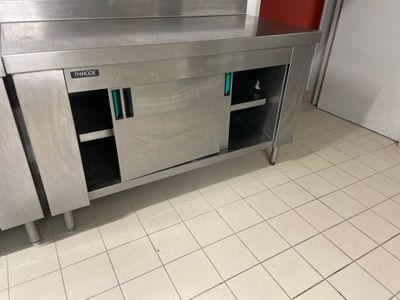 a stainless steel kitchen with a sink and a counter