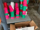 many different colored cups sitting on a shelf