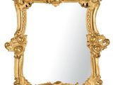 un miroir à cadre doré orné d'un motif décoratif