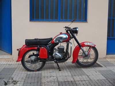 a red motorcycle parked on the side of the street
