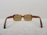 a close up of a pair of glasses on a white surface