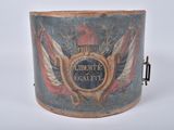 an old wooden bucket with a painting of a coat of arms and a shield on it