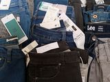 many different types of jeans on display in a store